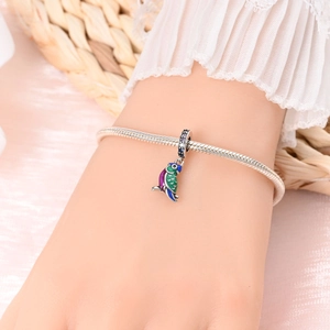 Silver snake chain bracelet with colorful parrot enamel charm and purple crystal accents