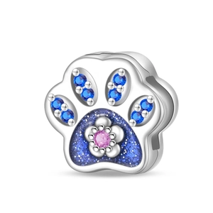 Close-up of paw charm with blue stones, starry enamel and silver flower detail