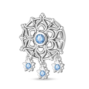 Macro shot of silver snowflake charm with blue gemstones and star pendants for jewelry