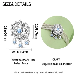 Detailed view of silver snowflake charm with blue zircon and star pendants, 20mm height