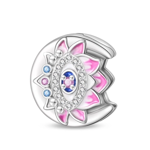 Macro shot of silver clover charm with pink gemstone and floral enamel details