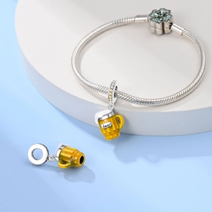 Macro detail of beer mug charms with yellow enamel on a silver snake chain bracelet