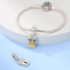 Macro detail of 925 silver beer mug charm with enamel flower clasp on snake chain