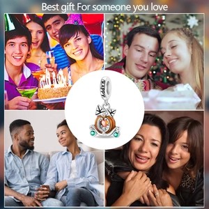Detail of pumpkin carriage charm with orange enamel and green gemstones with HAPPY engraving