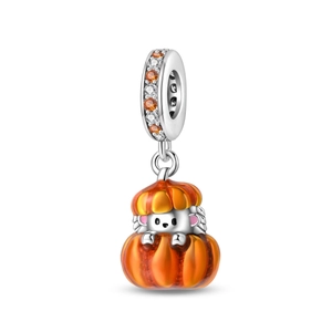 Macro detail of hedgehog inside an orange enamel pumpkin bead charm with zircon inlays