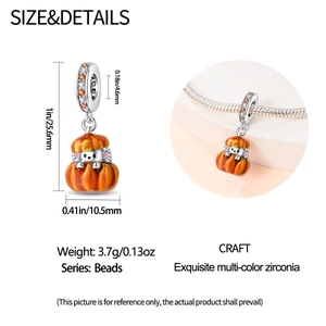 Detail view of pumpkin hedgehog charm with orange enamel and colorful zirconia stones