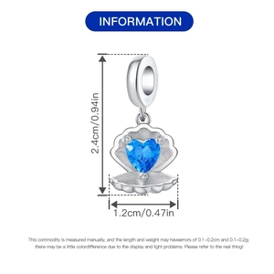Detailed view of silver shell charm featuring a blue heart gemstone and tiny diamond accents