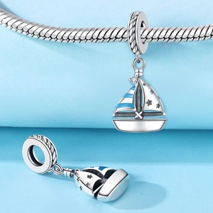 Detail of silver sailboat charm with blue enamel stripes and zircon for DIY bracelets