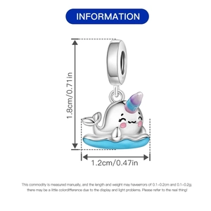 Detailed size view of silver narwhal charm with blue enamel and purple horn, 1.8cm high