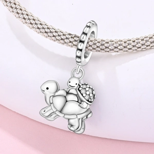 Silver mother and child turtle charm with white cubic zirconia on woven mesh bracelet