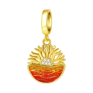 Macro shot of sunrise ocean charm with orange enamel waves and sparkling crystals