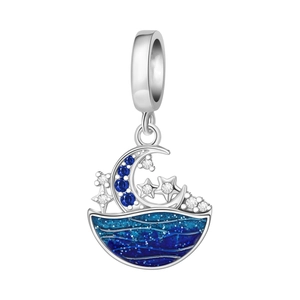 Macro shot of silver crescent moon and star boat charm with blue enamel and zircons