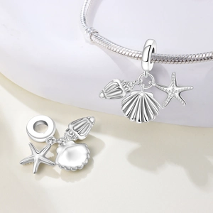 Polished silver ocean charms featuring starfish and shells on a snake chain bracelet