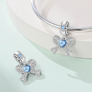 Bow-knot charm with heart blue gemstone and white zircon set in S925 silver finish