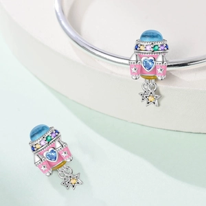 Macro detail of spaceship charm with blue heart stone and colorful zirconia for bracelet