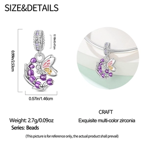 Detail showing butterfly and lily of the valley charm with purple enamel and zircon inlay