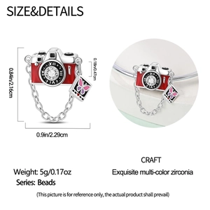 Macro shot of camera charm with red enamel and zircon detail for DIY bracelets