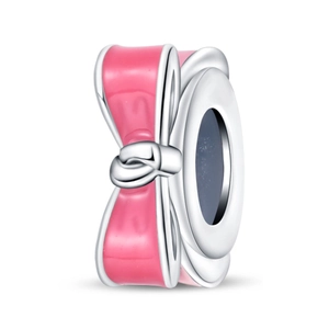 Detail of silver bead charm with pink enamel bow design for DIY jewelry bracelets