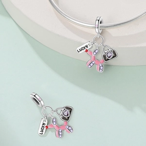 Detail of flamingo style charm with pink balloon dog and lucky tag for bracelets
