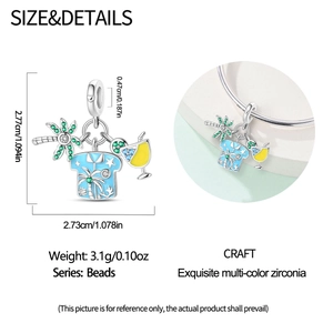 Detailed view of silver charm with palm tree, blue shirt, and yellow cocktail pendant