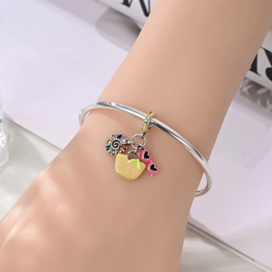 Silver open bangle featuring summer charms of sun, beach bag, and pink heart sunglasses