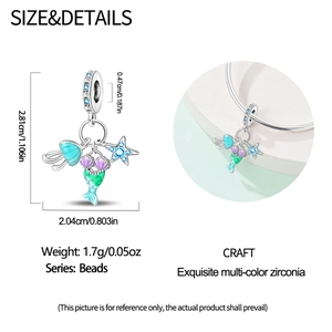 Detailed view of silver mermaid tail and shell bead with colorful zircon stones