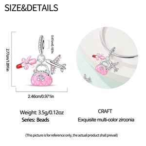 Macro detail of silver cocktail charms with pink handbag and airplane on a bracelet