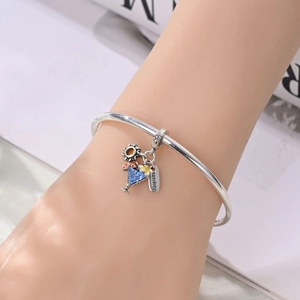 Silver charm bracelet with summer pendants including cocktail, sun, flower and summer tag