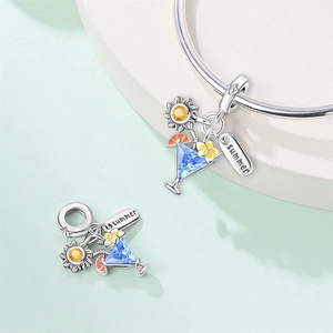 Detail of silver cocktail pendants with blue crystals and summer engraved charms