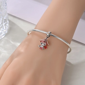 Close-up of a silver charm bracelet featuring a colorful pirate pendant with enamel finish