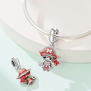 Detailed view of silver pirate charm with red enamel and yellow zircon on a bracelet