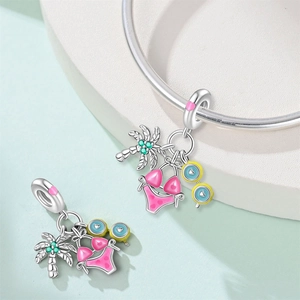 Silver summer beach charms with palm tree and bikini pendants on a stylish bracelet