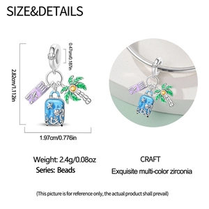 Detailed view of travel charms featuring blue suitcase and palm tree on a silver bead charm