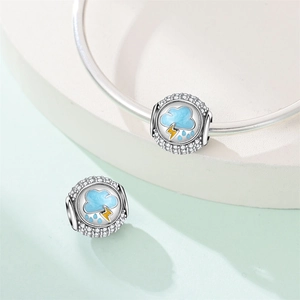 Macro shot of silver storm cloud charm with blue enamel rain and yellow lightning bolt