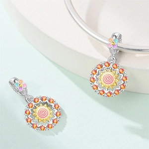 Detailed macro view of S925 silver sun charm with orange zircon and pink enamel work
