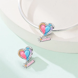 Detail of heart charm with colorful crystals and Sunny tag on silver bracelet