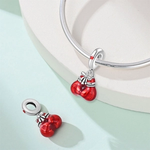 Detailed view of red enamel boxing glove charms for DIY bracelets in silver finish