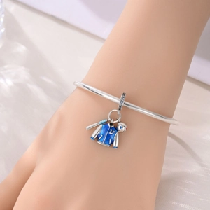 Silver baseball charm bracelet with blue enamel jacket and mini bat pendant on wrist
