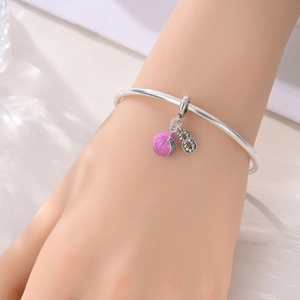 Detail of silver sports bracelet featuring pink enamel basketball and zircon number 8 charms