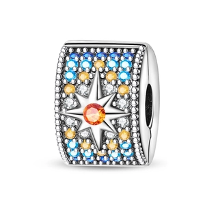 Macro shot of silver charm with colorful cubic zirconia and star-shaped details