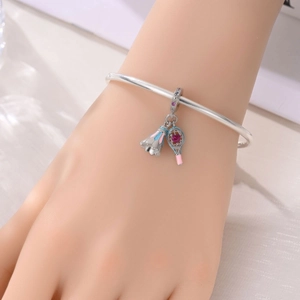 Silver sports bracelet featuring badminton racket and shuttlecock charms with pink gems