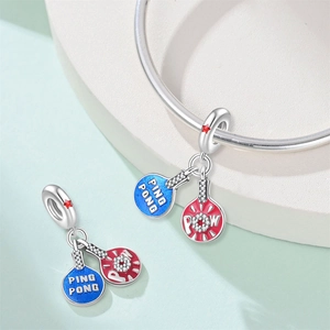 Macro detail of silver ping pong paddle charms with red and blue enamel finish
