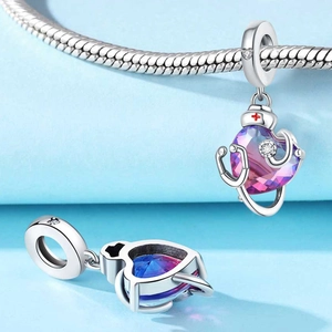 Macro shot of silver nurse heart charm with stethoscope and gradient gemstone on a snake chain