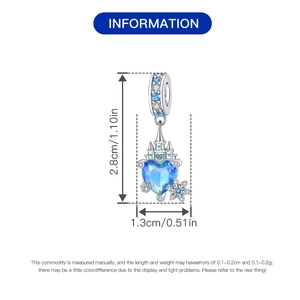 Detail view of heart-shaped blue gem charm with castle design and snowflake pendant