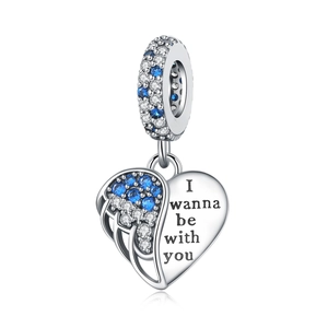 Detailed view of silver heart wing charm with blue zircons and engraved text