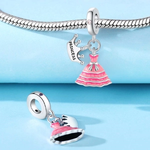 Silver Princess crown and pink enamel dress charms on a snake chain bracelet