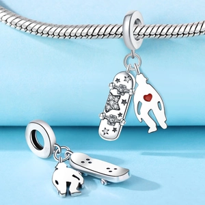Detail of silver skateboard and heart silhouette charms with red enamel and pavé crystals