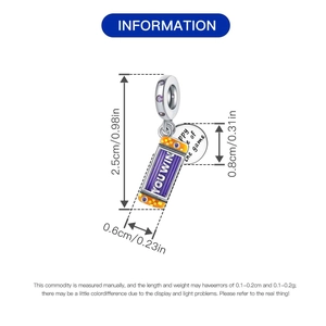 Detailed view of silver game console charm with purple zircon and You Win engraving