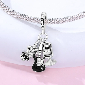 Detailed view of rock theme silver charm with guitar, microphone, and rock hand sign