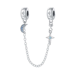 Macro detail of silver safety chain with blue moon and star charms for charm bracelets